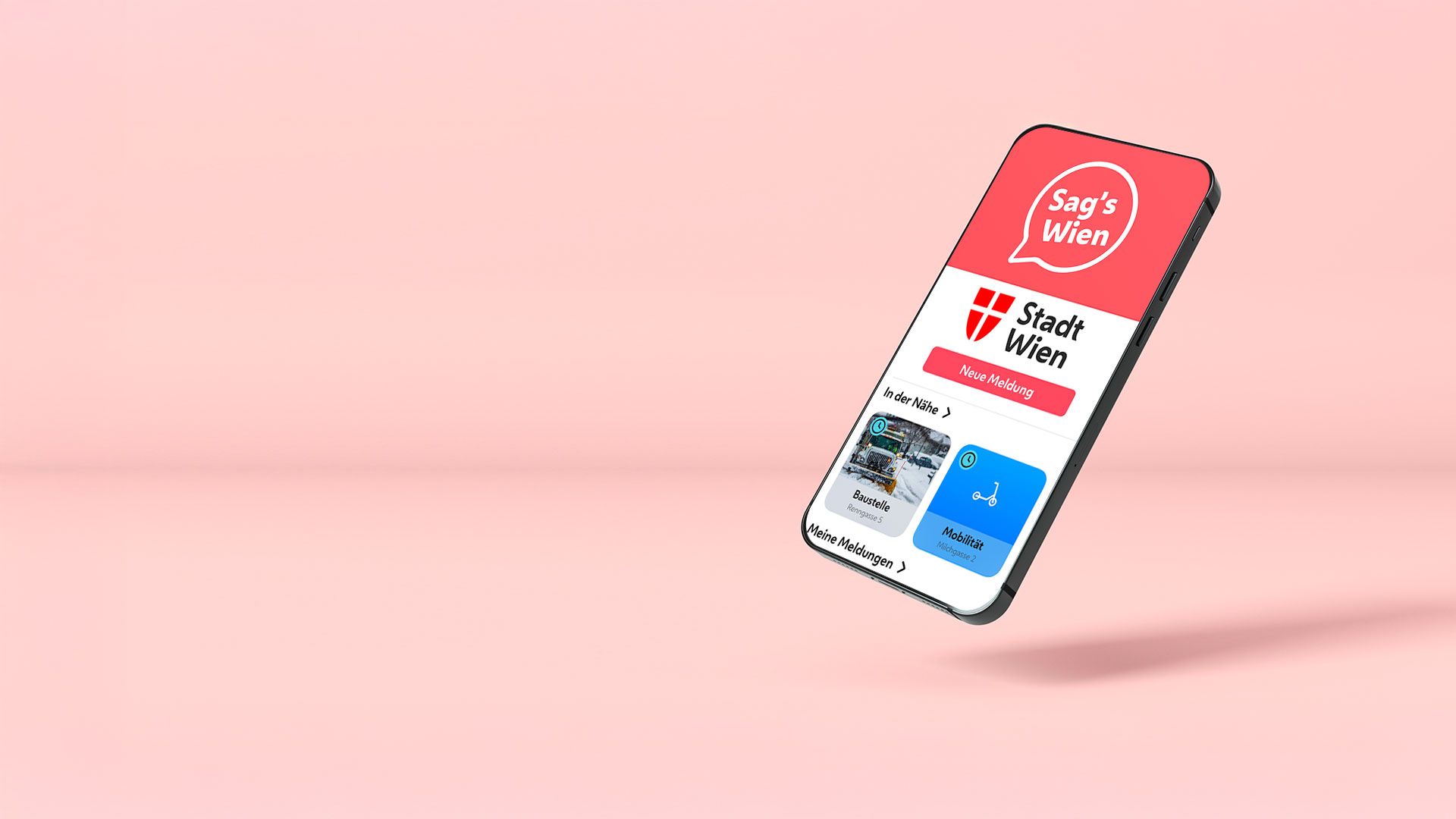 Smartphone mit geöffneter App "Sag's Wien" der Stadt Wien auf rosa Hintergrund